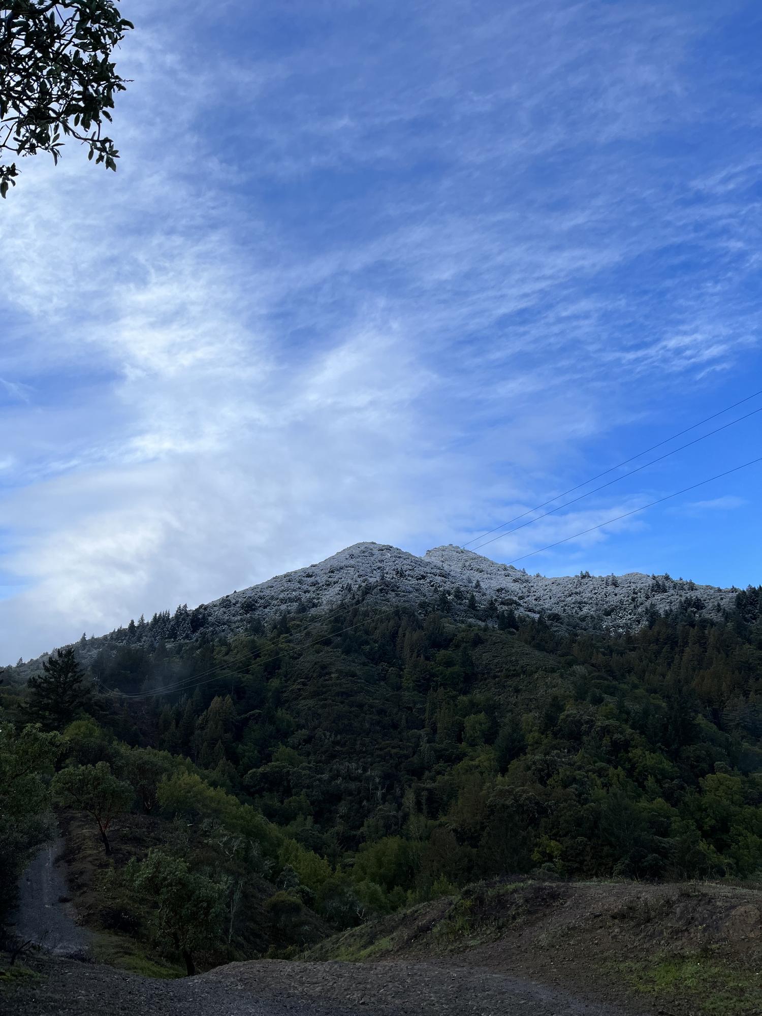 A rocky green ridgeline in Marin County under high morning cloud